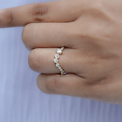 Silver curved eternity band with small round stones wrapped around the finger