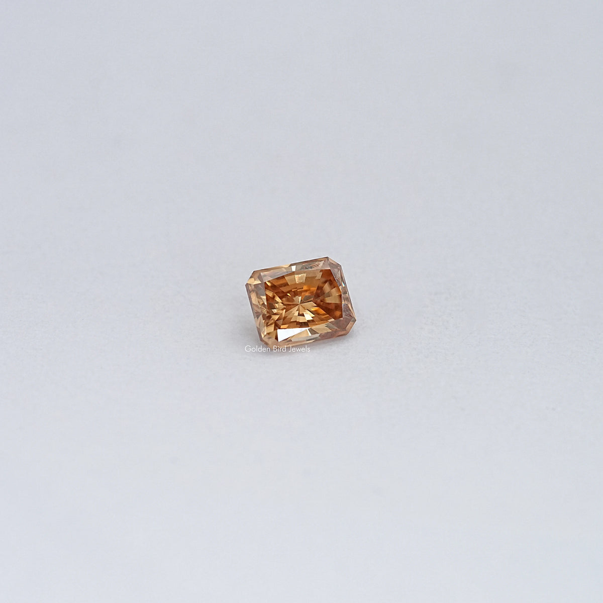 Champagne moissanite loose stone, small emerald-cut with facet sparkle