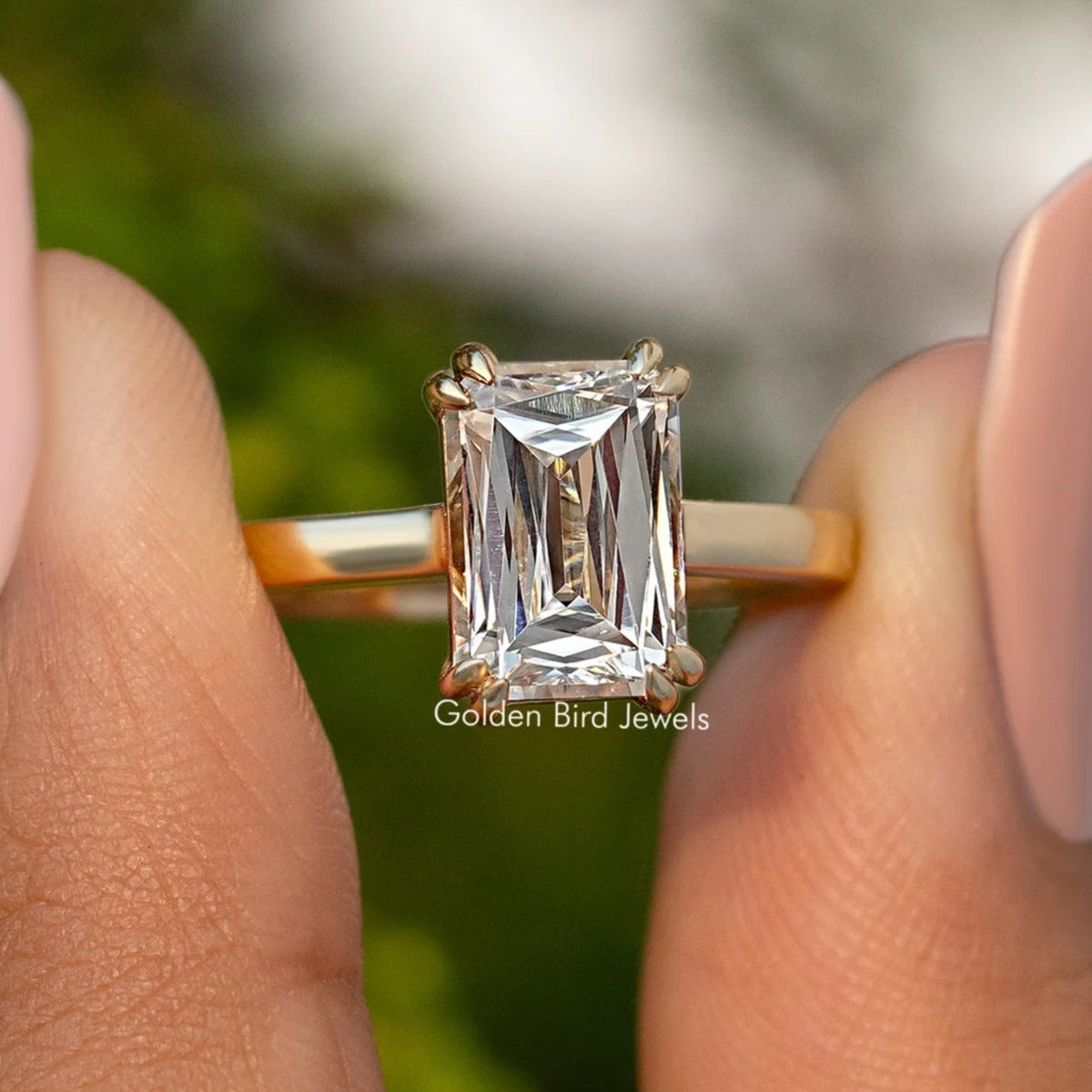 Moissanite solitaire engagement ring with rectangular cut stone, gold-tone band
