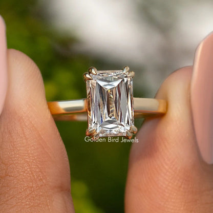Moissanite solitaire engagement ring with rectangular cut stone, gold-tone band