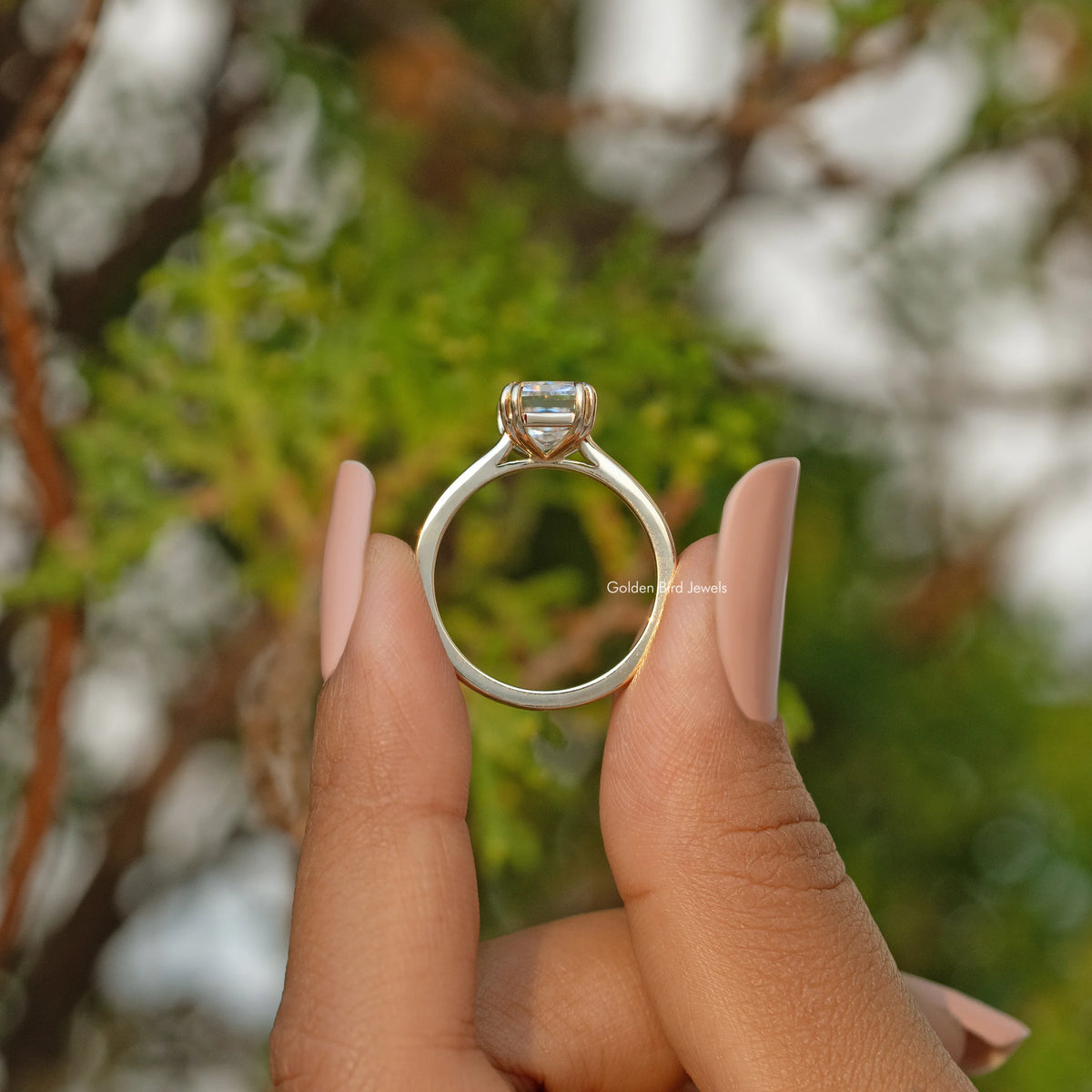 Moissanite solitaire engagement ring with four-prong rectangular stone, open top view