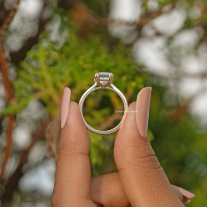 Moissanite solitaire engagement ring with four-prong rectangular stone, open top view