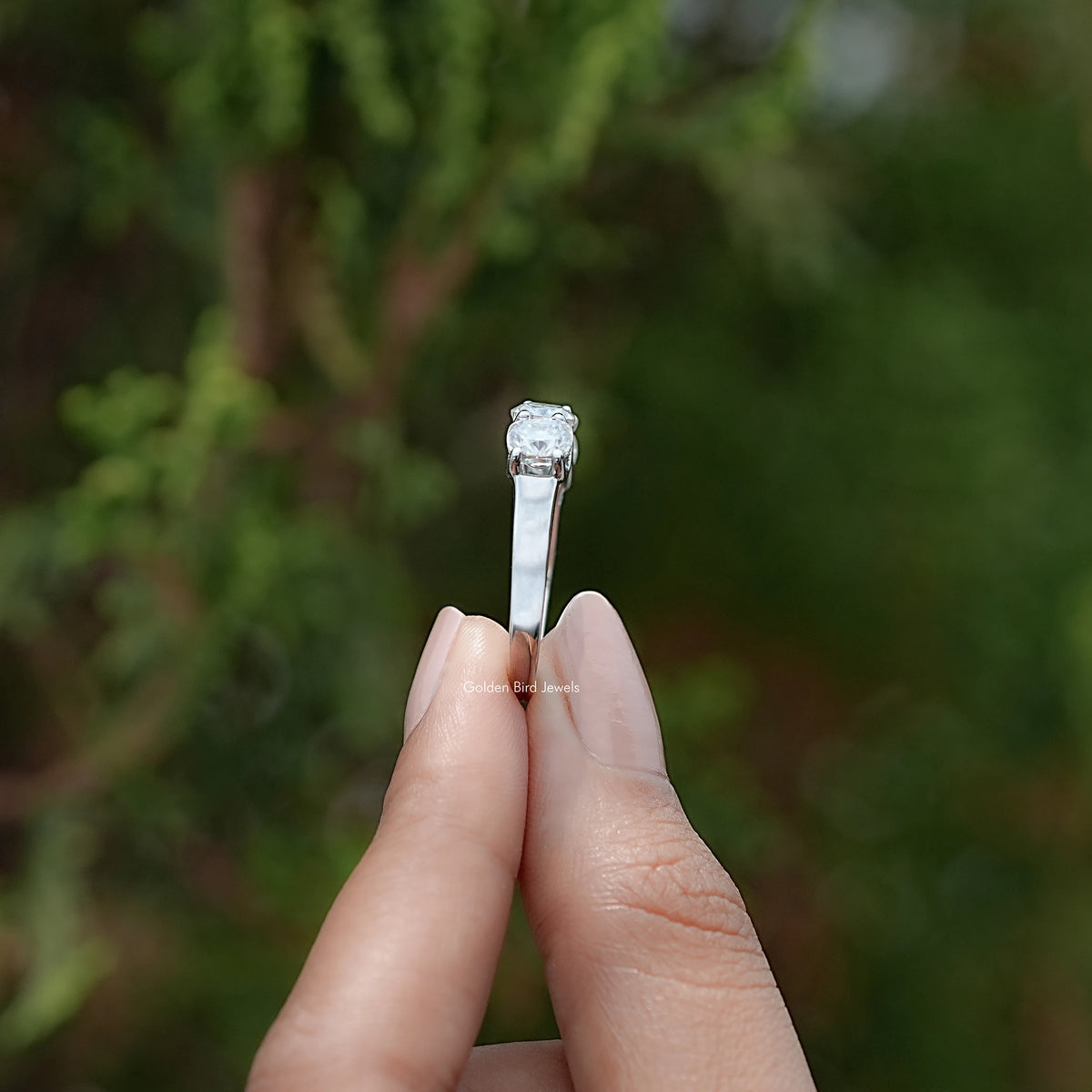 Silver moissanite cushion-cut solitaire-style top stone on a slim eternity band