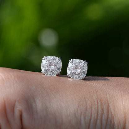 In Hand View Of a cushion cut moissanite stud Earring