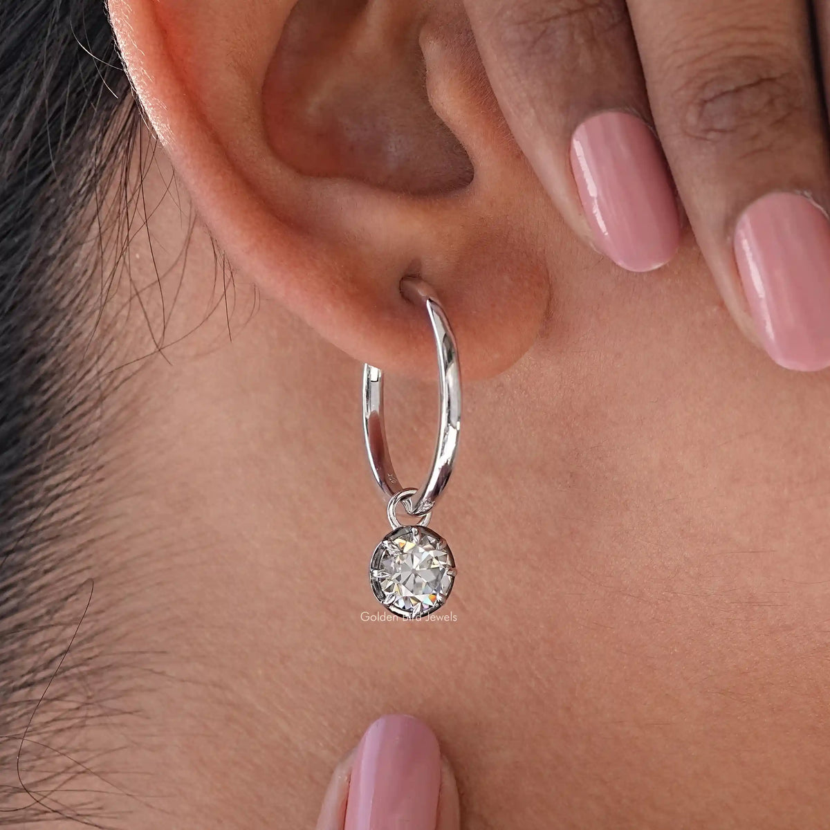925 sterling silver hoop dangle earring with round moissanite drop, close-up on ear