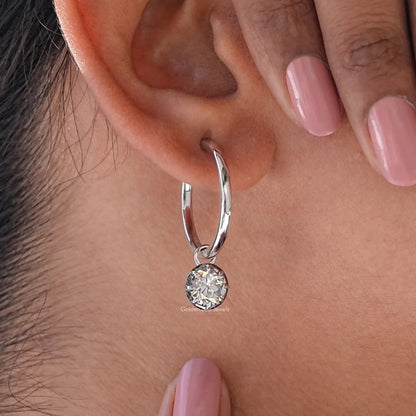 925 sterling silver hoop dangle earring with round moissanite drop, close-up on ear