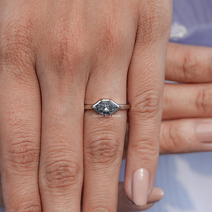Marquise-cut gray solitaire ring on finger with slim silver band