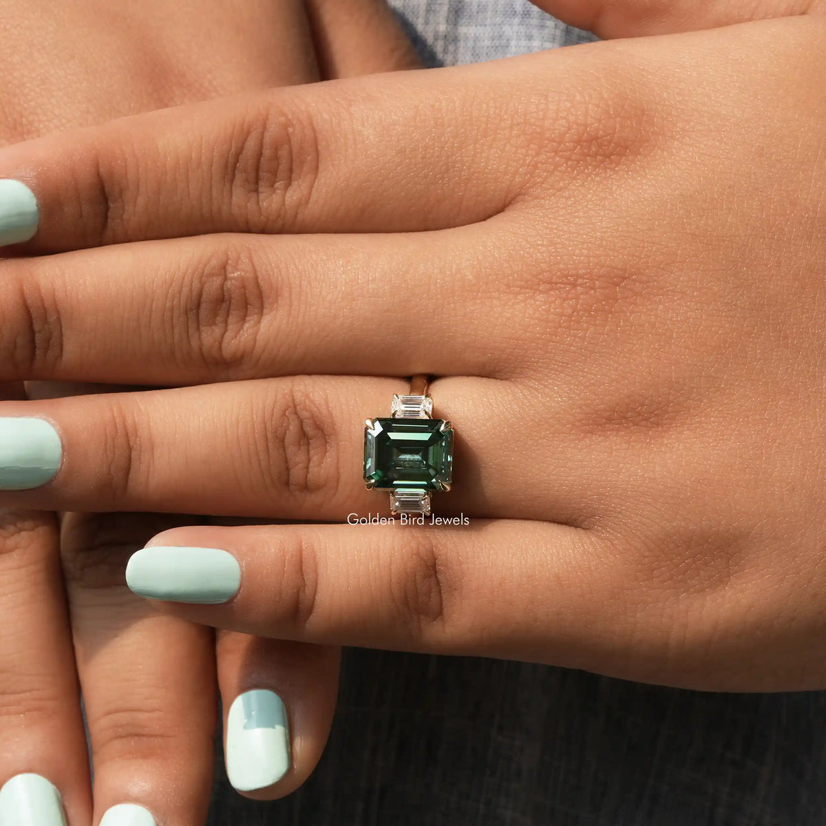 View of Three Stone Emerald Cut Ring In finger