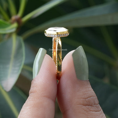 Side View of Moval Cut Hidden Halo Moissanite Ring In two fingers