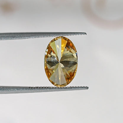 Oval champagne moissanite loose stone close-up with reflective facet pattern