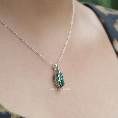 Side view of green marquise pendant In white Gold