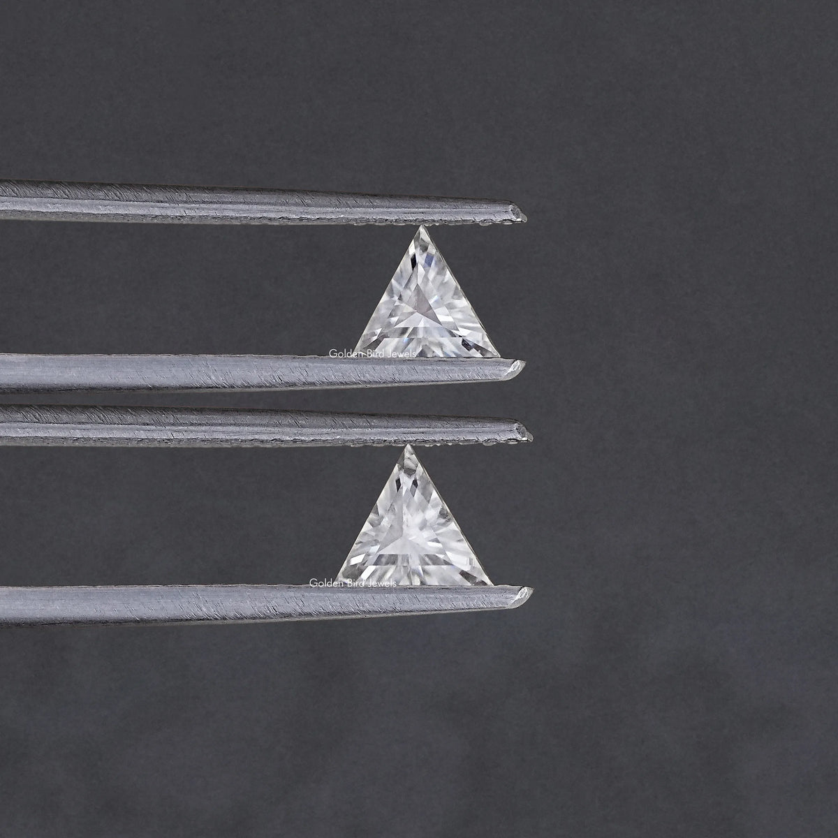 Triangle-cut clear moissanite stones, matching pair on silver tweezers