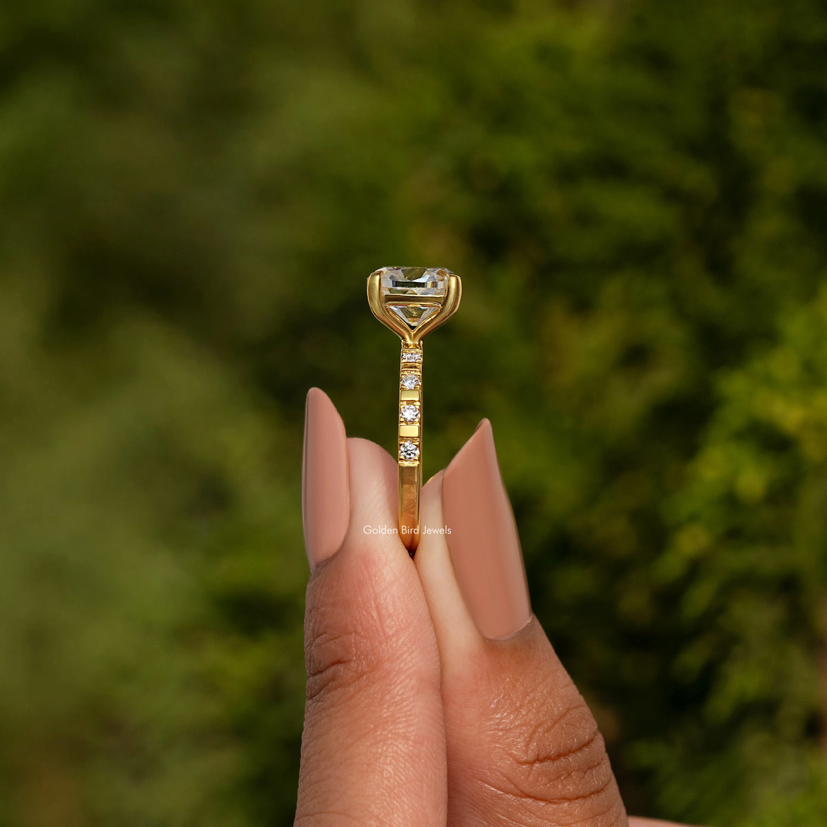 Gold-tone ring with cushion-cut center stone and prong setting on slim band