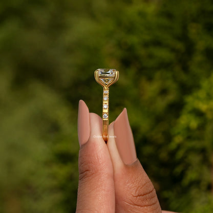 Gold-tone ring with cushion-cut center stone and prong setting on slim band