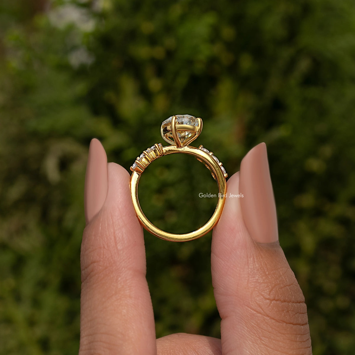 Gold-tone infinity ring band with oval old mine center stone and prong-set accents