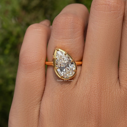 Gold-tone pear-cut solitaire engagement ring with prong-set center stone