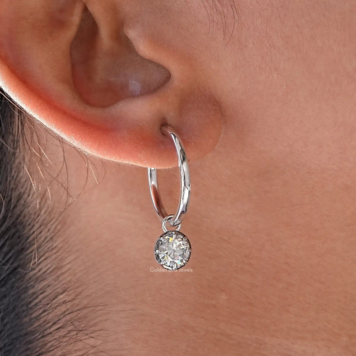 925 sterling silver hoop dangle earring with round moissanite drop, close-up on ear