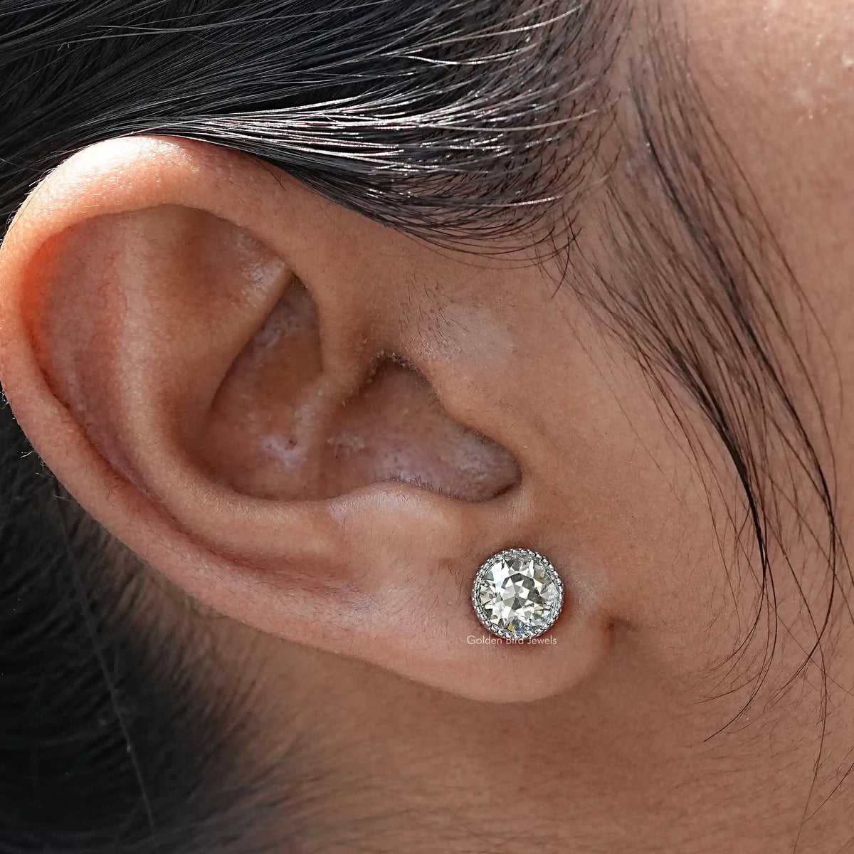 In close ear view of Round Cut Moissanite Stud Earrings