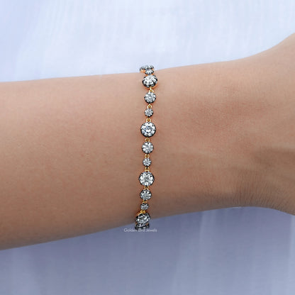 Round-stone tennis bracelet with bright silver setting, worn on wrist