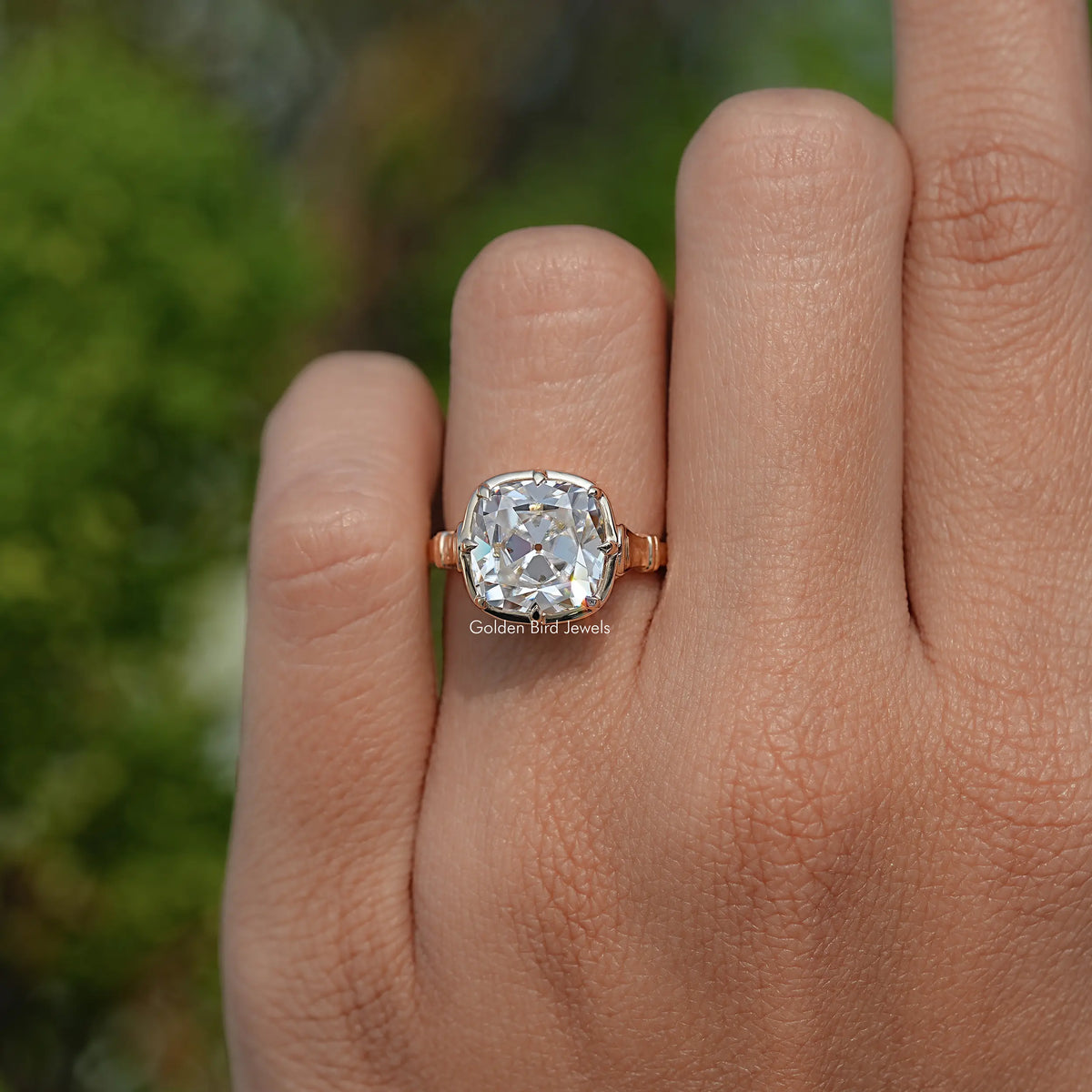 Gold cushion-cut moissanite solitaire ring on hand, front view