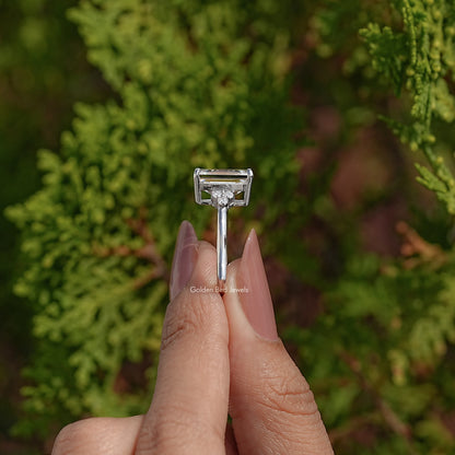 Side view of emerald-cut moissanite ring with prong-set rectangular center