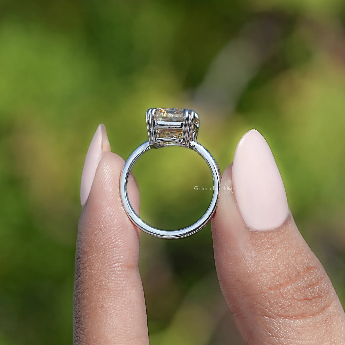 Emerald-cut moissanite solitaire ring, full view with silver band and square stone