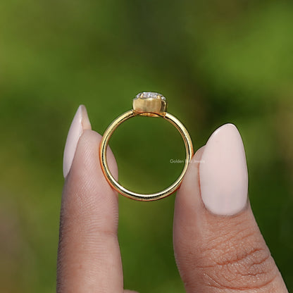 Oval bezel-set moissanite ring with gold band