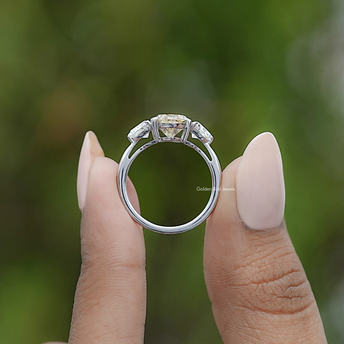 Three-stone ring back view, polished band with prong settings visible
