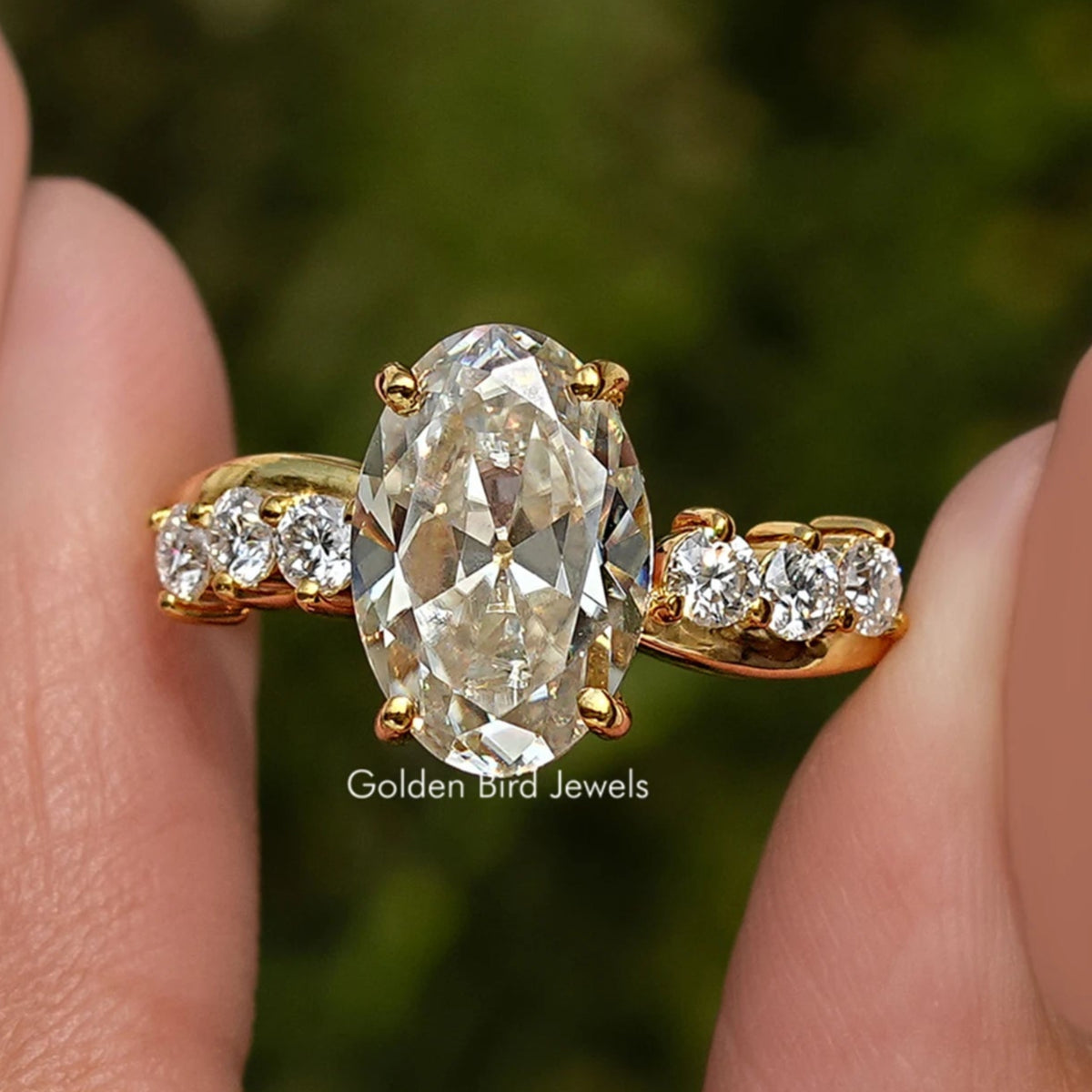 Gold-tone infinity ring with oval old mine center stone and round side stones