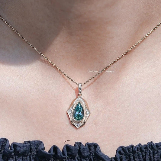 Pear-cut moissanite pendant necklace with teal center stone in a halo setting