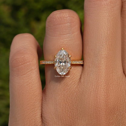 Oval moissanite accent stone ring in 925 sterling silver, shown on a finger.