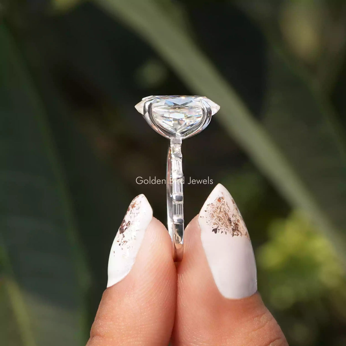 Side View of Oval Cut Moissanite Ring  In two fingers