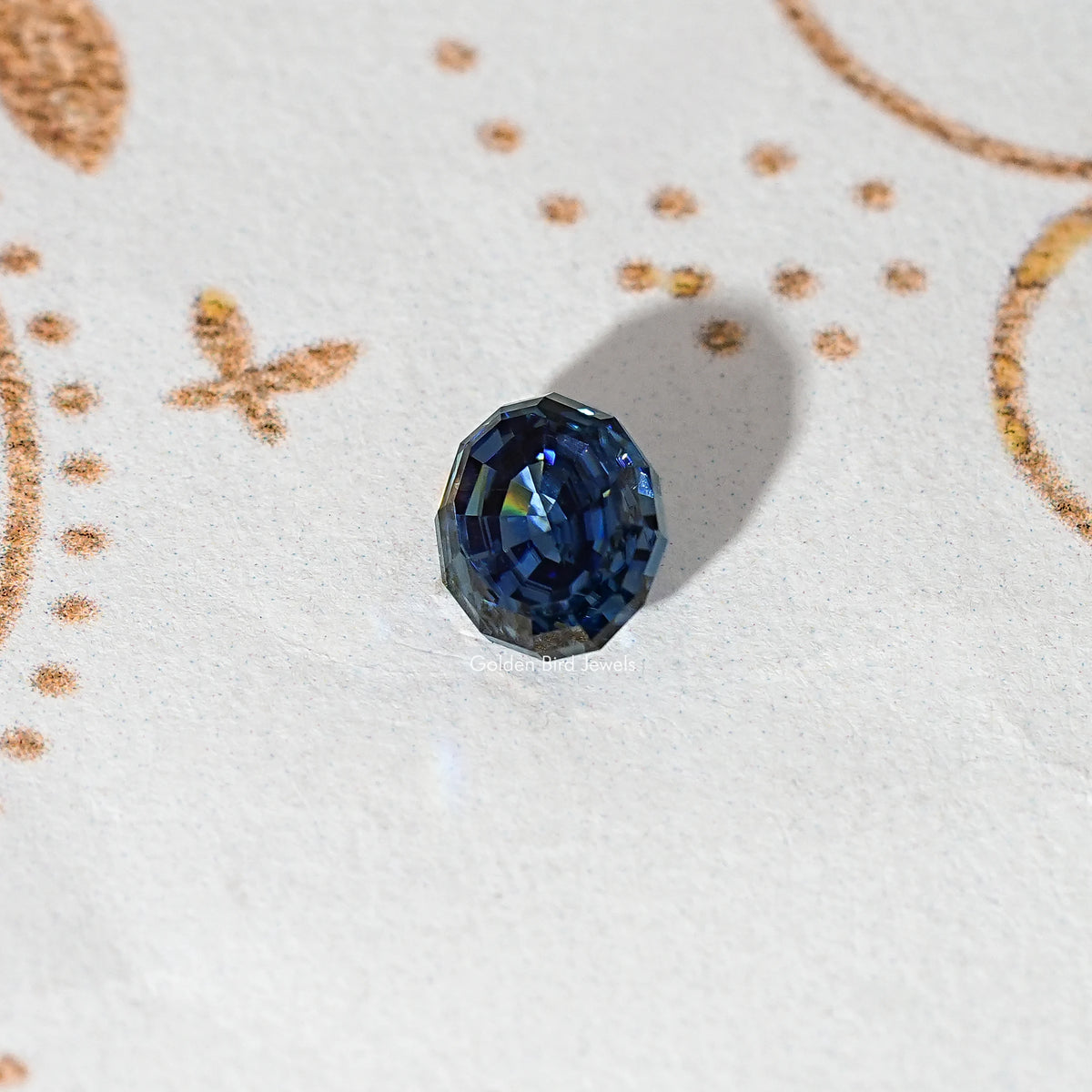 Loose step-cut oval blue moissanite gemstone shown from a slight angle