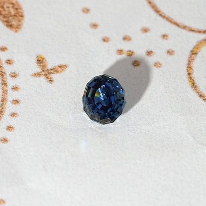 Loose step-cut oval blue moissanite gemstone shown from a slight angle