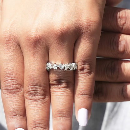 White metal moissanite eternity band with sparkling faceted stones along the top edge