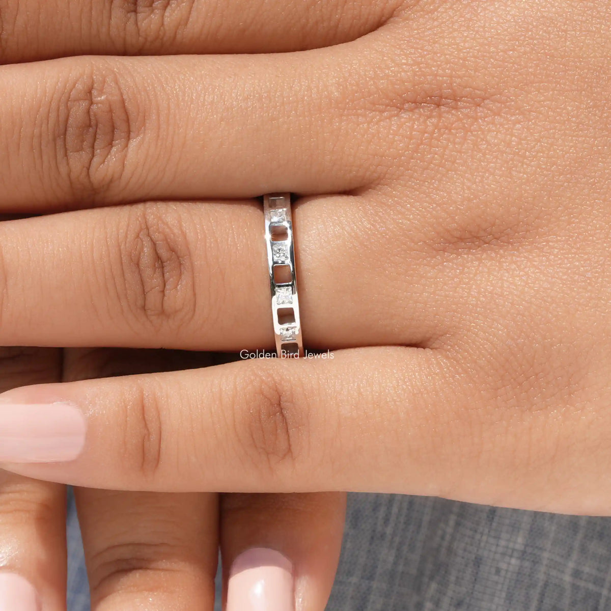 925 sterling silver moissanite eternity band with princess-cut stones set in a row, side view