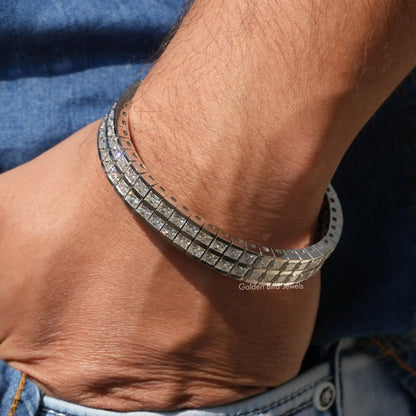 Men's tennis bracelet with silver prong-set stones, side view on wrist