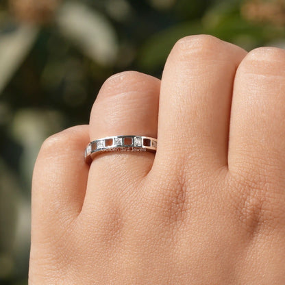 925 sterling silver eternity band with princess-cut moissanite stones, centered on finger