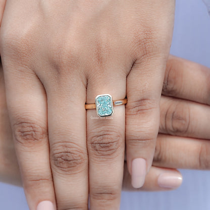 Blue moissanite bezel solitaire ring viewed from above on hand