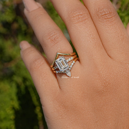 Three-stone bridal ring with curved bands, rectangular center stone close-up