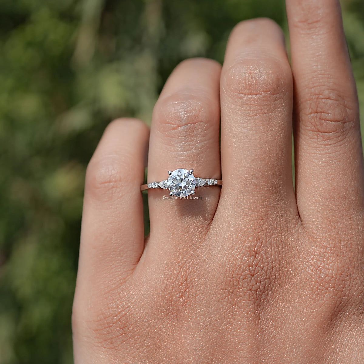 In finger view of Round Cut Moissanite Accent Set Engagement Ring