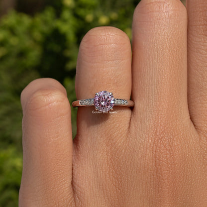 Round-cut moissanite accent ring in sterling silver, shown on a finger