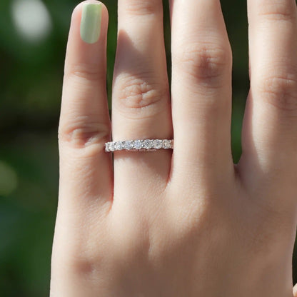 Silver half-eternity ring with a row of round-cut stones across the top