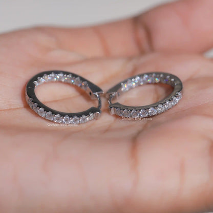 Round-cut moissanite huggie hoop earrings with dark metal and full stone surround