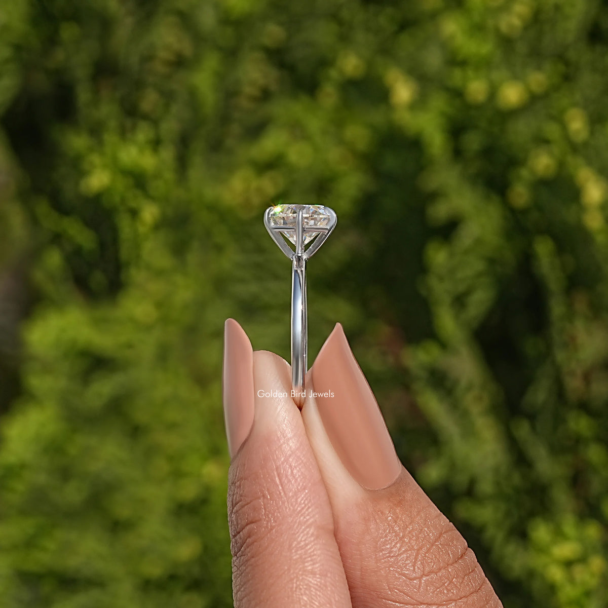 Round-cut moissanite solitaire bridal ring, sterling silver prongs and slim band