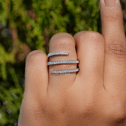 Silver moissanite spiral eternity band with round-cut stones, front view on finger