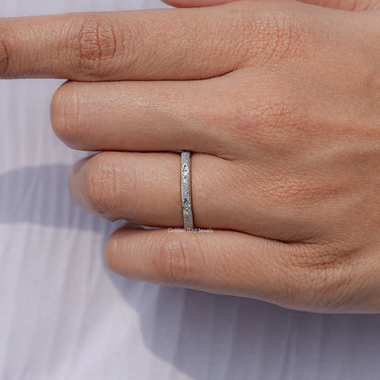 Silver ring worn on finger, slim eternity band with round stones