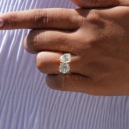 Two-stone toi et moi ring with pear-cut and round moissanite stones