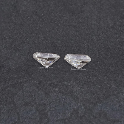 Shield-cut moissanite gemstones pair, clear shield-cut stones, two pieces side by side