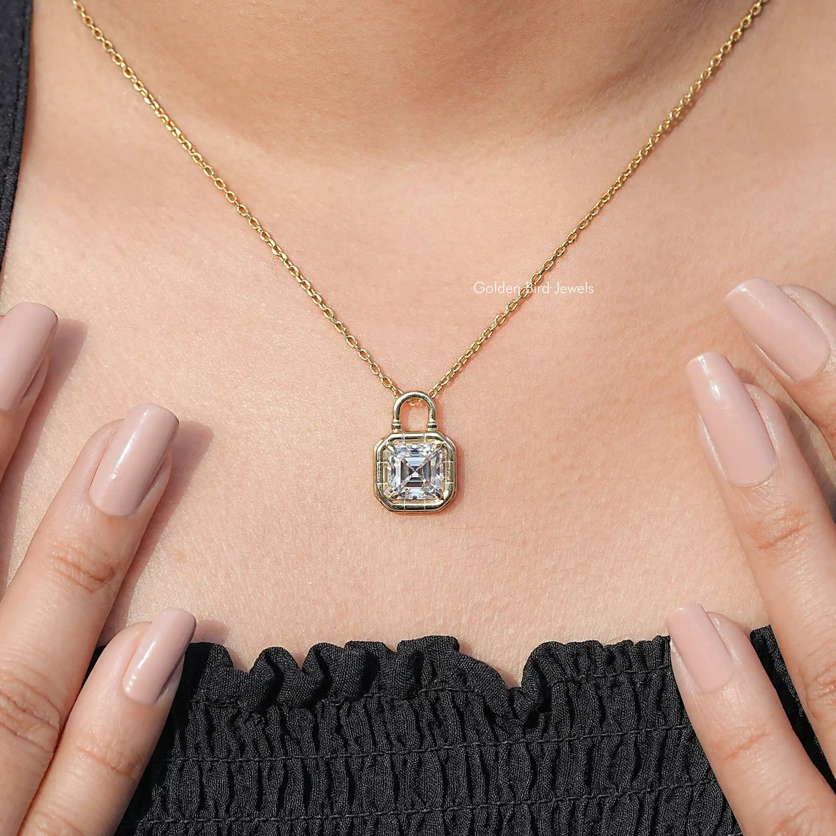 Square moissanite solitaire pendant with halo-style bezel on a gold-tone chain